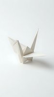 White origami paper crane folded from clean paper on neutral background for craft projects and creative designs.
