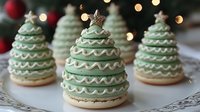 Festive Christmas tree cookies with green icing and white decorative details topped with star anise, holiday baking treats for seasonal celebrations.