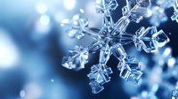 Crystalline snowflake macro photography in blue tones showing intricate frozen water structure with natural bokeh background, winter seasonal nature detail.