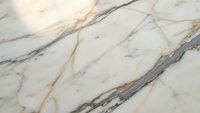 Elegant white marble surface with golden and gray veining patterns creating luxurious natural stone texture for interior design and architectural applications.