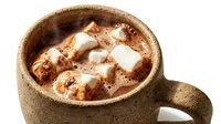 Steaming hot chocolate with fluffy marshmallows in a rustic ceramic mug, isolated on white background, cozy winter drink concept.