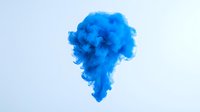 Blue ink swirling in water creates ethereal abstract cloud formation against light background, capturing dynamic fluid motion in vibrant cyan tones.