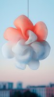Soft gradient coral and white balloon cloud formation floating against pastel blue sky with urban skyline backdrop, creating dreamy atmospheric composition.