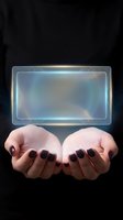 Woman with dark red manicure holding glowing holographic rectangle interface against black background. Futuristic technology concept for digital innovation and virtual communication design.