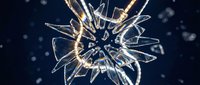Shattered glass explosion with bright sparks and fragments flying against dark blue background for dynamic design projects and creative concepts.