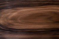 Natural brown wooden texture with dark wavy grain pattern and smooth surface showing organic flow lines and rich walnut tones for furniture design.