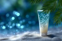 Sparkling cosmetic cream tube on white sand with tropical palm leaves and blue bokeh background, luxury skincare product photography.