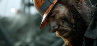 Weathered male miner with beard and safety helmet in dramatic side profile against moody industrial background, harsh lighting creates atmospheric mining scene.