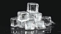 Pile of clear ice cubes on black background with water droplets and reflections, creating refreshing cold drink concept for summer beverages.