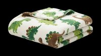 Folded quilted throw blanket with green and brown dinosaur pattern on cream background, isolated on transparent background. Ready for product mockups, e-commerce, home decor designs, print-on-demand, and lifestyle marketing.