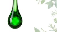 Isolated green liquid droplet suspended in mid-air against white background with botanical foliage elements, suitable for eco-friendly design, wellness branding, and environmental graphics.