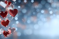 Red and pink hearts hanging on string with soft bokeh lights background for romantic Valentine's Day celebration and love themed designs.