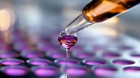 Liquid droplet falling from glass pipette into purple solution in laboratory well plate, macro photography with bokeh effect in background for science research.
