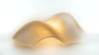 Abstract golden wave form with smooth curves and warm lighting on white background for modern design projects.