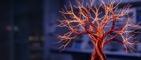 Copper wire tree sculpture with intricate branching design against blurred blue background for artistic home decor and craft projects.