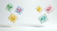 Colorful gift boxes with ribbons floating on white background, isolated presents for holiday shopping, celebrations, and festive design projects.
