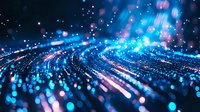 Glowing blue particles and light trails create dynamic motion effect with bokeh and sparkles on dark background, suitable for technology and digital concepts.
