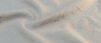 Soft beige sand dunes with gentle curves and natural wind patterns creating abstract desert landscape texture for backgrounds and nature designs.