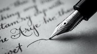 Fountain pen with metal nib writing cursive script on white paper, capturing calligraphy and handwriting for correspondence, education, and artistic projects.