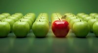 Red apple standing out among green apples on gradient background symbolizing uniqueness, leadership, and individuality in business concepts.