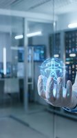 Hand holding glowing digital power grid network in modern server room, representing energy distribution, smart grid technology, and electrical infrastructure management.