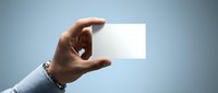 Professional businessman hand holding blank white business card against gradient background for corporate branding and marketing materials.