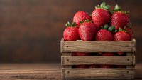 Fresh ripe strawberries in rustic wooden crate against dark background, selective focus. Natural organic produce for healthy eating and food photography.