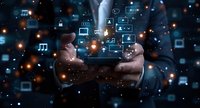 Digital transformation concept with hands holding mobile device surrounded by glowing tech icons and virtual interface elements in dark blue atmosphere.