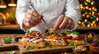 Professional chef preparing gourmet holiday appetizers on wooden board in restaurant kitchen with festive Christmas lights creating warm atmosphere.