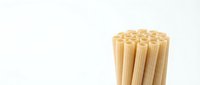 Bunch of wooden bamboo sticks isolated on white background, ready for crafts, food service, or design projects.