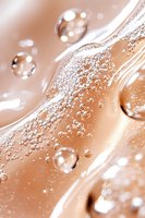 Luxurious foundation texture with bubbles and swirls in nude beige tone, macro shot showing cosmetic product consistency and air bubbles for beauty industry.