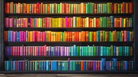 Colorful rainbow gradient bookshelf filled with hardcover books arranged by color from warm red and orange tones to cool blues, perfect for education, library, or knowledge concepts.