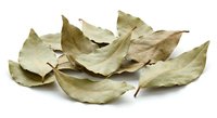 Dried bay leaves scattered on white background, aromatic culinary herbs for cooking and seasoning, natural spice ingredient isolated for design use.