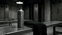 Water bottle and towel on gym bench in modern fitness facility with industrial concrete interior and overhead lighting.