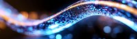 Abstract blue glowing wave with sparkles and bokeh effects on dark background, futuristic light trail design element for technology concepts.