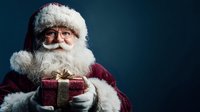 Traditional Santa Claus with white beard and glasses holding wrapped gift box with gold bow against dark blue background. Perfect for holiday marketing.