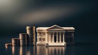 Stacks of coins next to miniature bank building with columns representing financial growth, savings, investment and banking services concept.