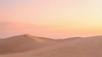 Serene desert landscape at sunset with rolling sand dunes under soft pink and golden sky, suitable for travel and nature backgrounds.