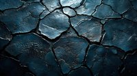 Dramatic cracked earth texture in dark blue tones with deep shadows and highlights creating abstract pattern. Natural disaster drought concept.