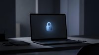 Modern laptop displaying glowing blue padlock icon on screen in dark office environment representing cybersecurity and data protection concepts.