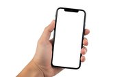 Hand holding modern smartphone with blank white screen isolated on white background for mockup design and app presentation.