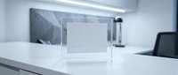 Modern minimalist acrylic display stand on white desk in contemporary office setting for product presentation and professional showcasing.