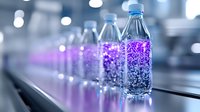 Plastic water bottles with glowing purple liquid on production line, illuminated by neon lights creating mystical atmosphere in manufacturing facility. Suitable for beverage industry.