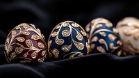 Luxurious Easter eggs decorated with golden floral patterns on dark velvet background. Burgundy and navy ornate holiday decorations create elegant festive atmosphere.