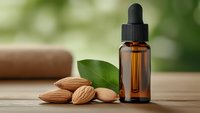 Amber glass dropper bottle with almond oil and fresh almonds on wooden surface for natural skincare and aromatherapy wellness treatments.