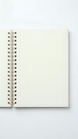 Open spiral notebook with blank cream pages and metal wire binding on white background for writing notes and creative projects.