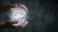 Protective hands surrounding glowing brain hologram symbolizing mental health care, neurology research, and cognitive protection against dark background.
