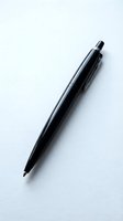 Black ballpoint pen isolated on white background, ready for design use on stationery, office supplies, and business marketing materials.