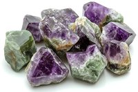 Raw fluorite crystal chunks showing natural purple and green color variations, rough mineral specimens with translucent surfaces on white background for geology study.