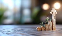 Wooden blocks arranged as ascending graph with growing plant, symbolizing sustainable business growth and eco-friendly development on blurred background.